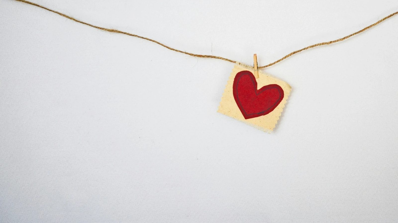 A heart symbol on a delicate thread